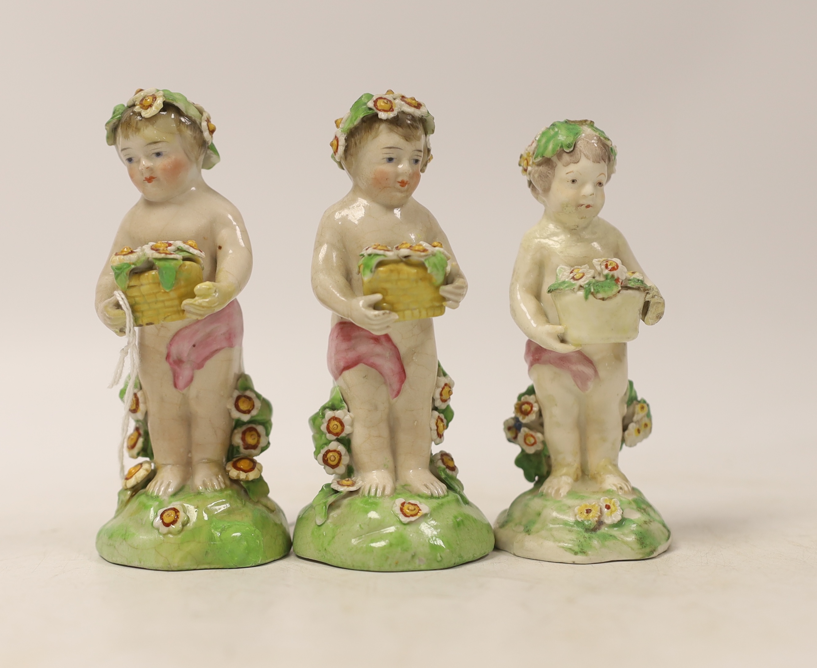 A group of three Chelsea style putti/nymphs, 11.5cm high